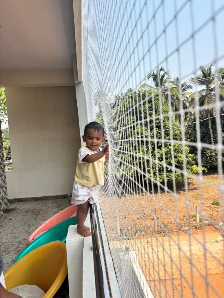 Children safety net installation on high-rise balcony - Swathi Safety Nets